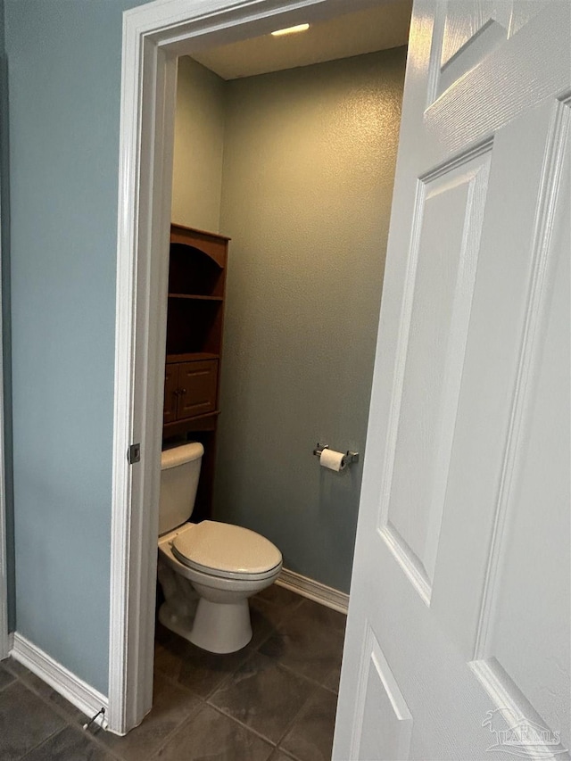 bathroom featuring tile patterned floors and toilet