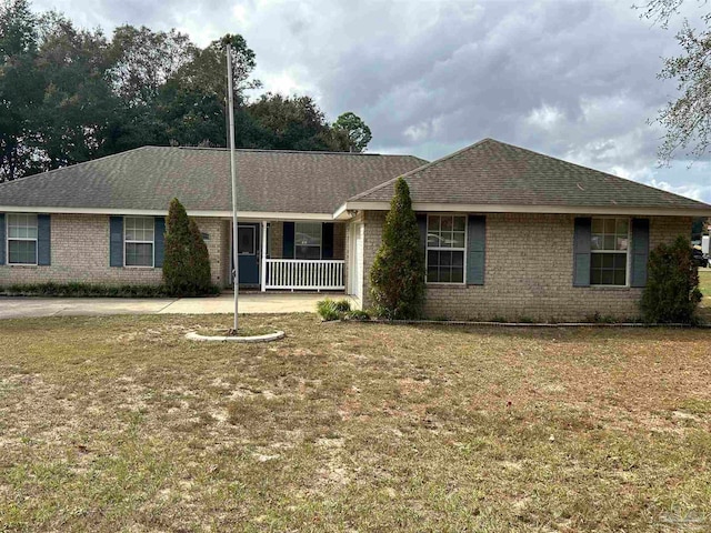 single story home featuring covered porch and a front lawn