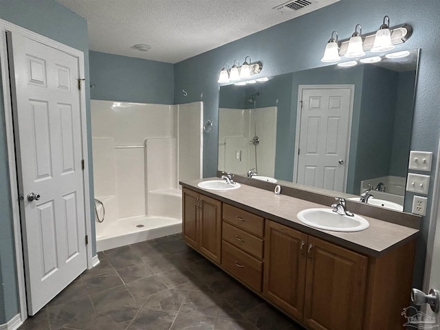 bathroom with separate shower and tub, tile patterned flooring, vanity, and a textured ceiling