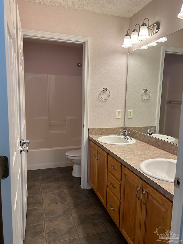 full bathroom with shower / bath combination, tile patterned floors, vanity, a textured ceiling, and toilet