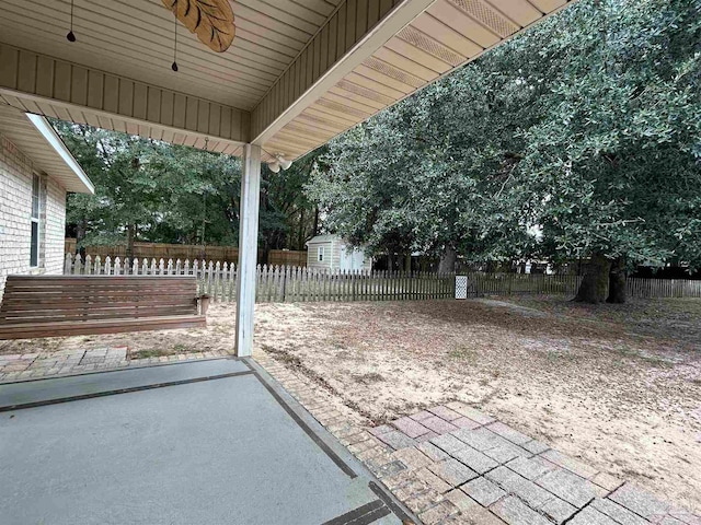 view of patio featuring a shed and ceiling fan