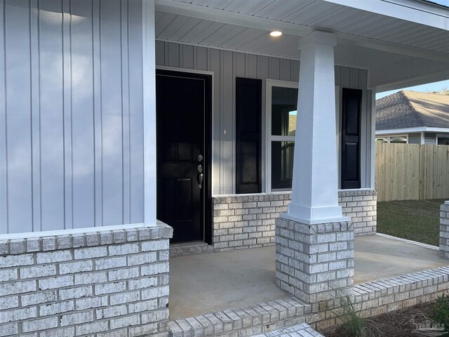 view of exterior entry with covered porch