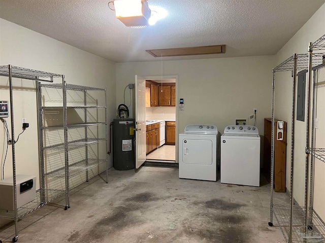 clothes washing area with a textured ceiling, independent washer and dryer, electric panel, and water heater