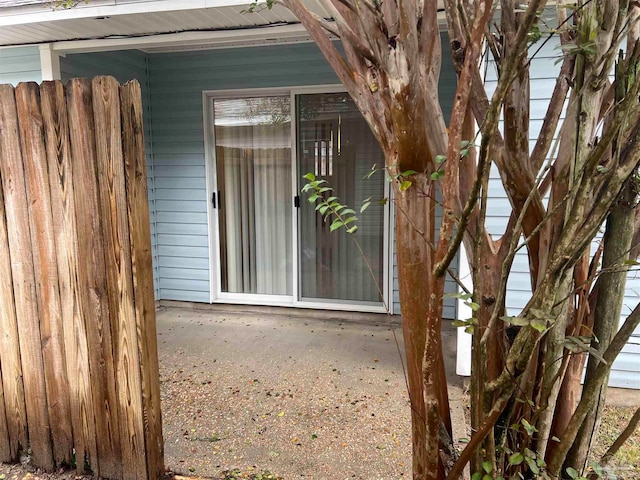 view of exterior entry featuring a patio area