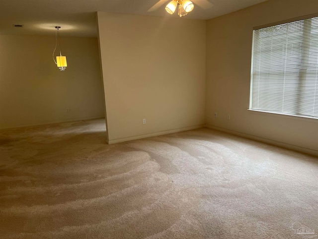 spare room with ceiling fan and carpet floors