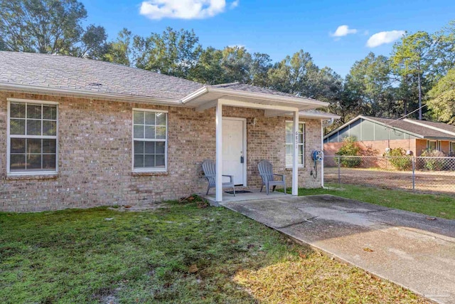 view of front of property with a patio area and a front yard