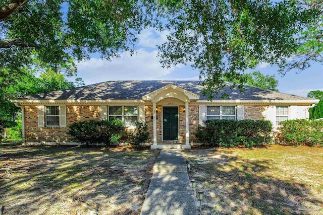 single story home with brick siding and a front lawn