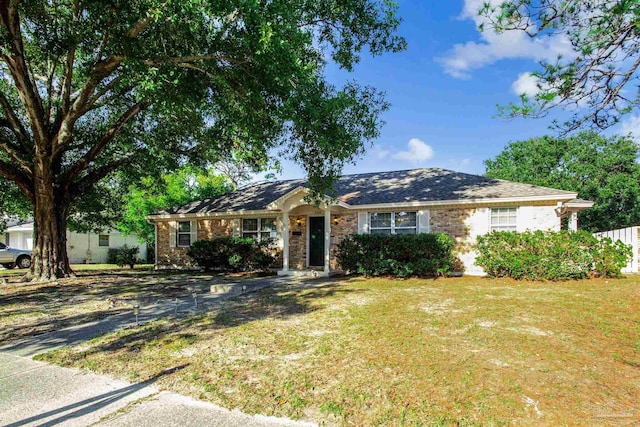 ranch-style home with a front lawn and brick siding