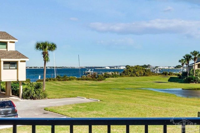 surrounding community with a lawn and a water view