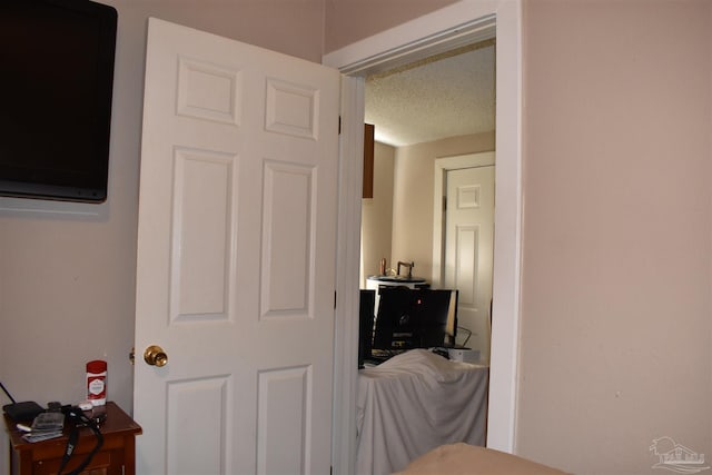 hall featuring a textured ceiling