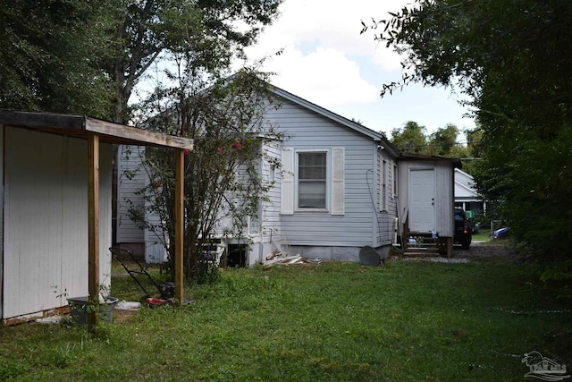 view of side of property with a yard