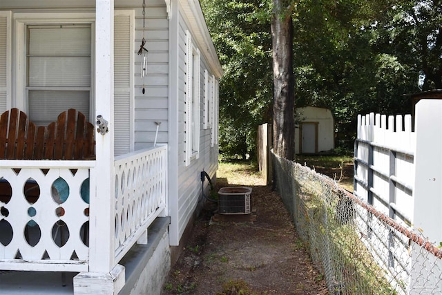 view of home's exterior with a shed and central air condition unit