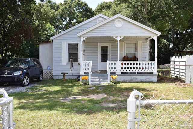 bungalow-style house with a front lawn and covered porch