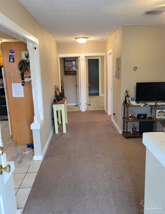 6017 Montgomery Ave, Pensacola, FL 32526 - hallway featuring a textured ceiling, electric panel, baseboards, and visible vents