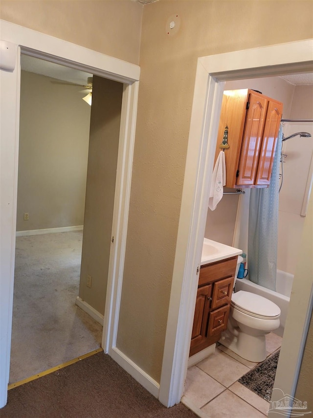 full bathroom featuring toilet, ceiling fan, tile patterned floors, shower / bath combination with curtain, and vanity