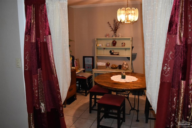 tiled dining space featuring a chandelier