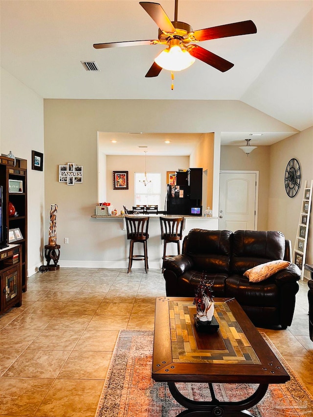 living room featuring tile patterned flooring, vaulted ceiling, and ceiling fan