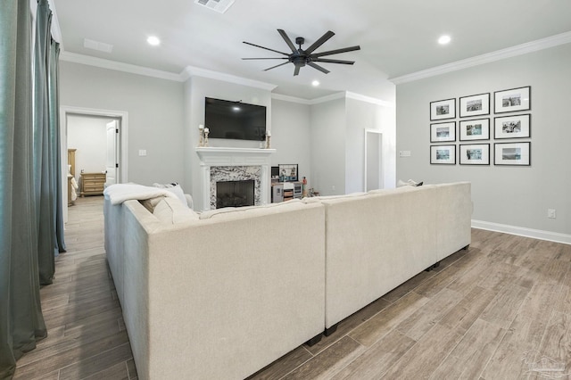 1567 Sawyers Ridge Cv, Cantonment, FL 32533 - living room featuring ceiling fan, a premium fireplace, recessed lighting, wood finished floors, and ornamental molding