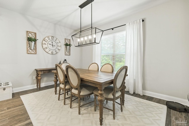 1567 Sawyers Ridge Cv, Cantonment, FL 32533 - dining room with a chandelier and dark wood-style flooring