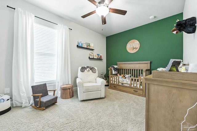 1567 Sawyers Ridge Cv, Cantonment, FL 32533 - bedroom featuring carpet, a nursery area, an accent wall, and a ceiling fan