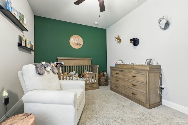 1567 Sawyers Ridge Cv, Cantonment, FL 32533 - bedroom with light carpet, a nursery area, a ceiling fan, and an accent wall