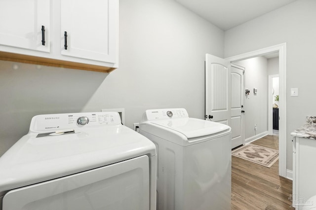 1567 Sawyers Ridge Cv, Cantonment, FL 32533 - laundry area with separate washer and dryer, cabinet space, and wood finished floors