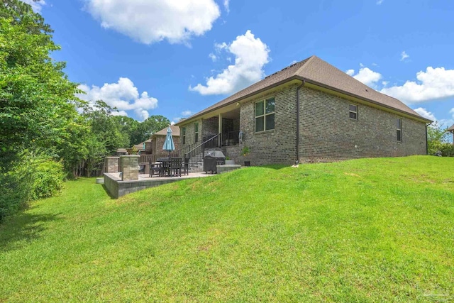 1567 Sawyers Ridge Cv, Cantonment, FL 32533 - rear view of house featuring a patio, brick siding, and a lawn