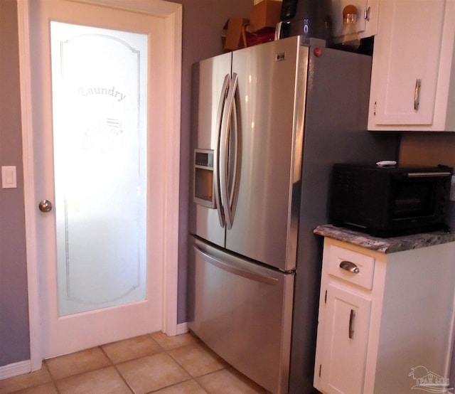 7067 Pine Blossom Rd, Milton, FL 32570 - kitchen featuring stainless steel refrigerator with ice dispenser, white cabinets, and light tile patterned flooring