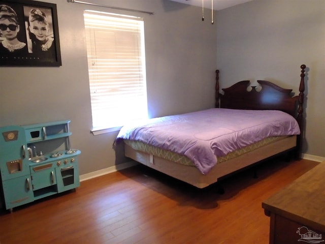 7067 Pine Blossom Rd, Milton, FL 32570 - bedroom with baseboards and wood finished floors