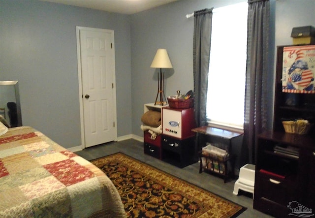 7067 Pine Blossom Rd, Milton, FL 32570 - bedroom featuring baseboards and wood finished floors