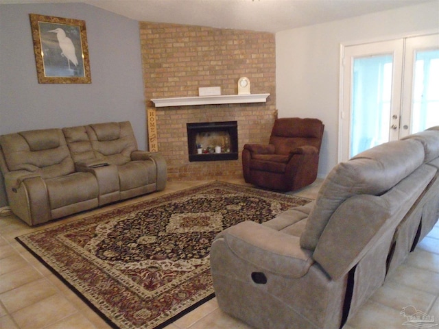 7067 Pine Blossom Rd, Milton, FL 32570 - living area with light tile patterned floors, a brick fireplace, and vaulted ceiling