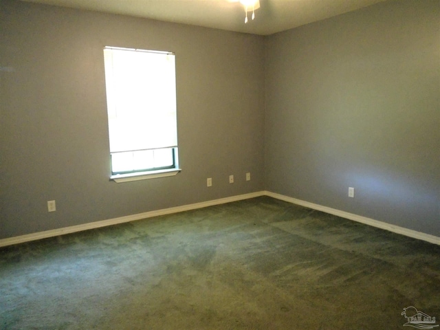 7067 Pine Blossom Rd, Milton, FL 32570 - spare room with baseboards and dark colored carpet