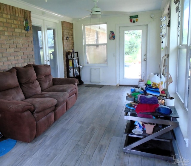 7067 Pine Blossom Rd, Milton, FL 32570 - living area with wood finished floors, a ceiling fan, and brick wall