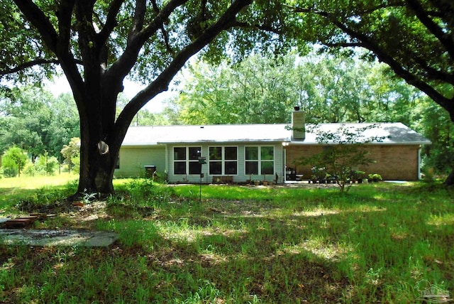 7067 Pine Blossom Rd, Milton, FL 32570 - rear view of property with a chimney