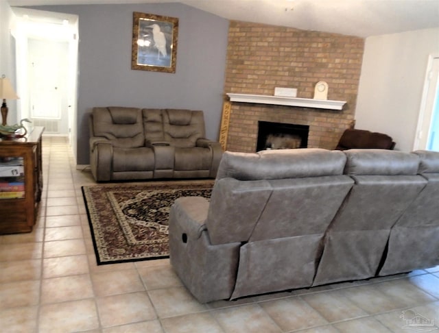 7067 Pine Blossom Rd, Milton, FL 32570 - living room featuring a fireplace, light tile patterned floors, and vaulted ceiling