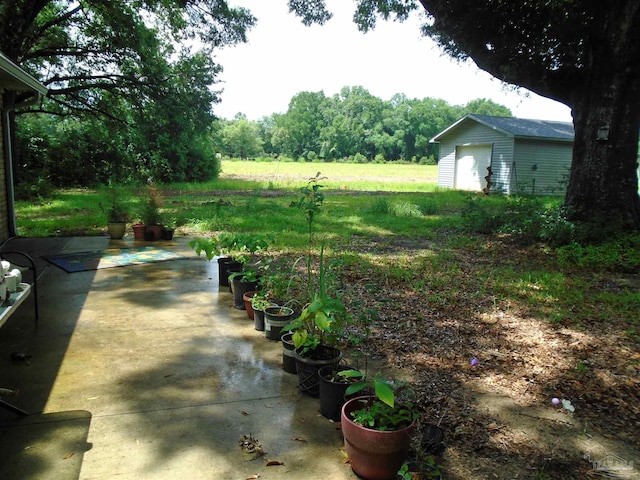 7067 Pine Blossom Rd, Milton, FL 32570 - view of yard featuring an outdoor structure and a patio