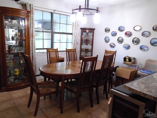 7067 Pine Blossom Rd, Milton, FL 32570 - dining space with light tile patterned floors and a chandelier