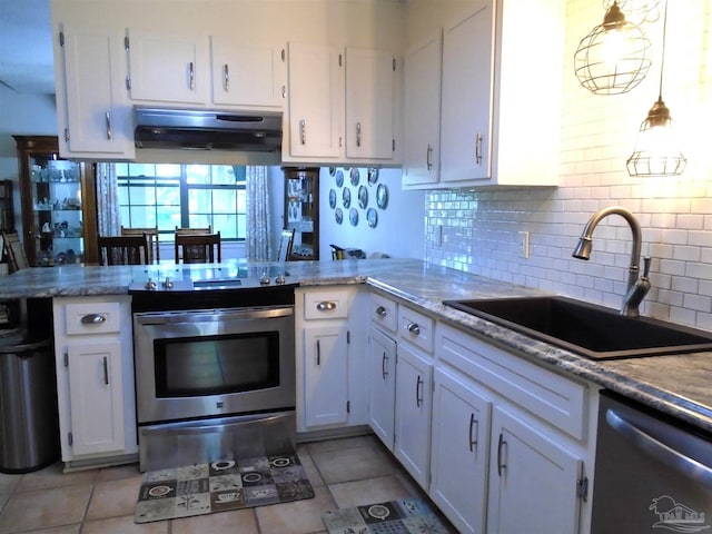 7067 Pine Blossom Rd, Milton, FL 32570 - kitchen with appliances with stainless steel finishes, a peninsula, white cabinetry, and decorative backsplash