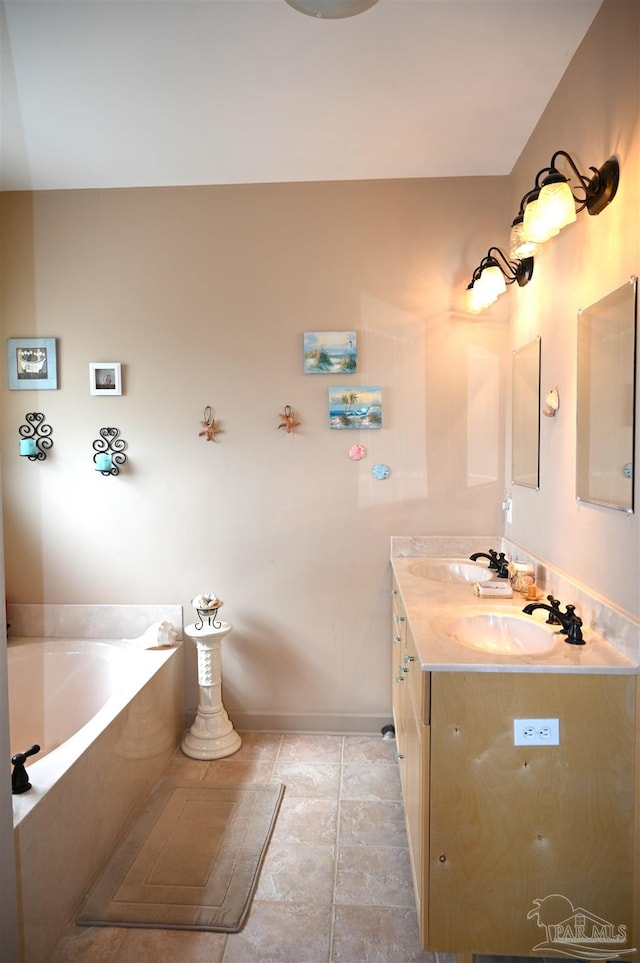 bathroom with vanity, tile patterned floors, and a bathing tub