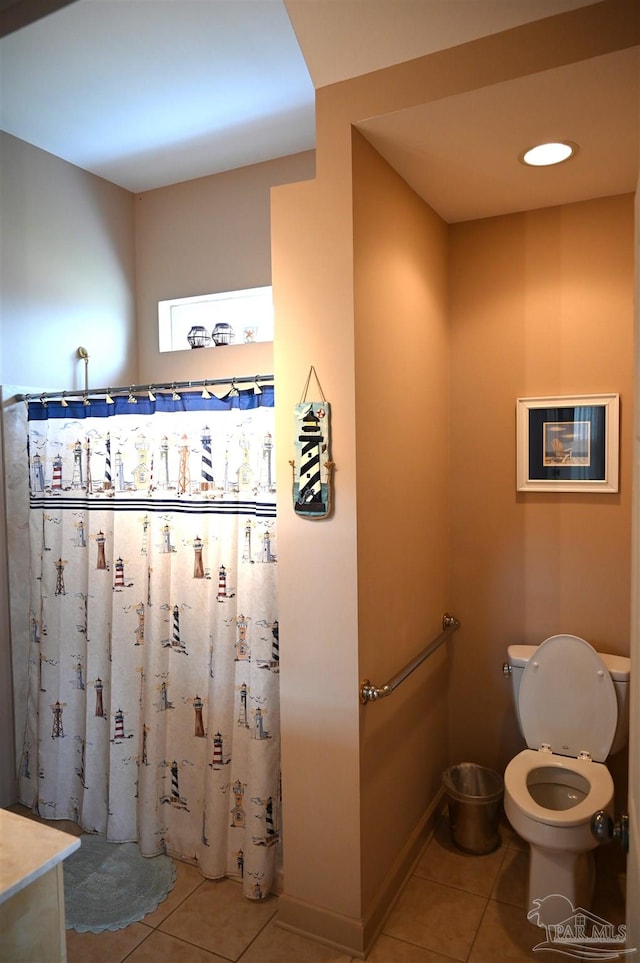 bathroom featuring vanity, tile patterned floors, and toilet