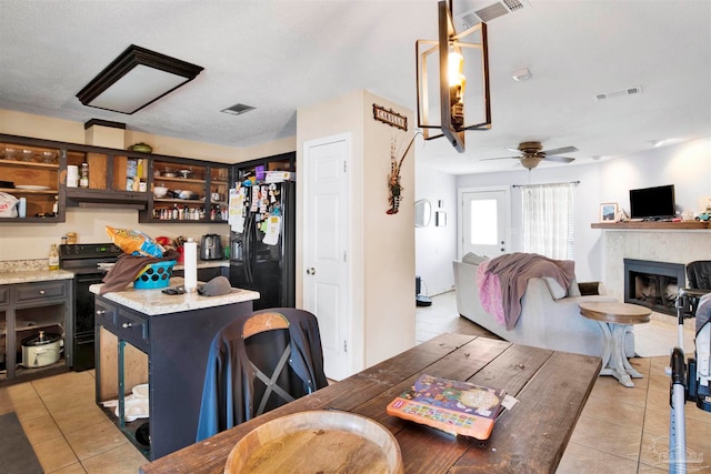 tiled dining area with ceiling fan