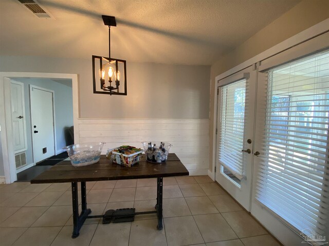 kitchen featuring a center island, black appliances, range hood, and a wealth of natural light