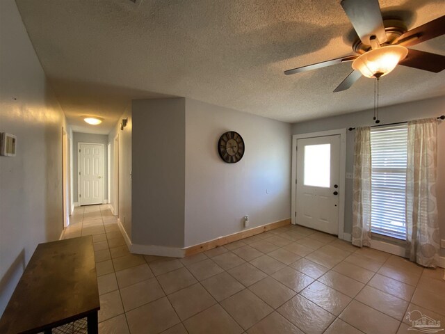 living room featuring ceiling fan, a textured ceiling, and dark hardwood / wood-style flooring