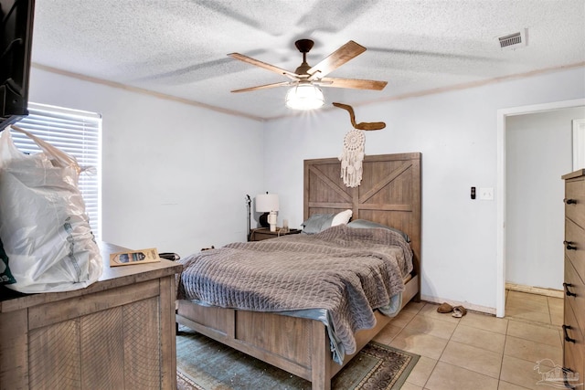 bedroom featuring light tile patterned flooring, a textured ceiling, and ceiling fan