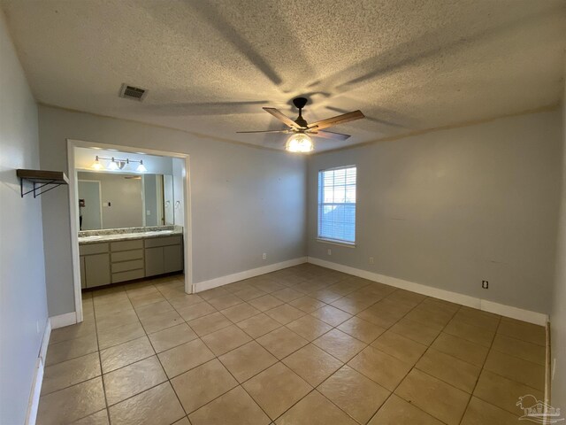 bedroom with a nursery area, light tile patterned floors, and ceiling fan