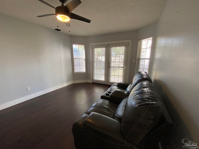 living room featuring french doors, ceiling fan, a textured ceiling, and dark hardwood / wood-style flooring