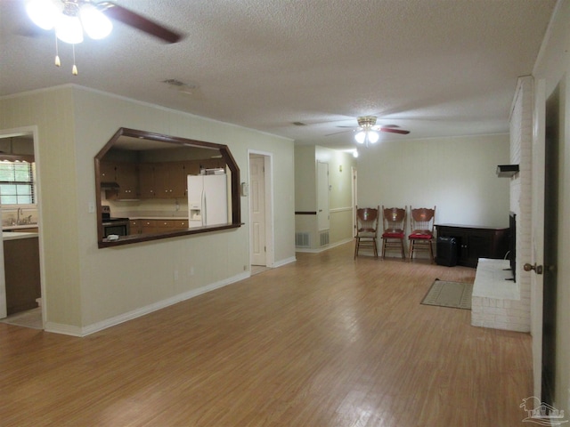 5078 Babb Ln, Pace, FL 32571 - living area with a ceiling fan, wood finished floors, a textured ceiling, arched walkways, and crown molding