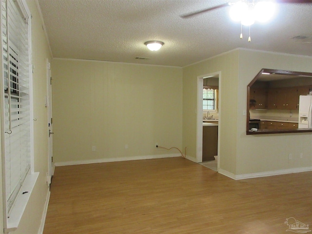 5078 Babb Ln, Pace, FL 32571 - unfurnished room with light wood finished floors, ceiling fan, a textured ceiling, and ornamental molding