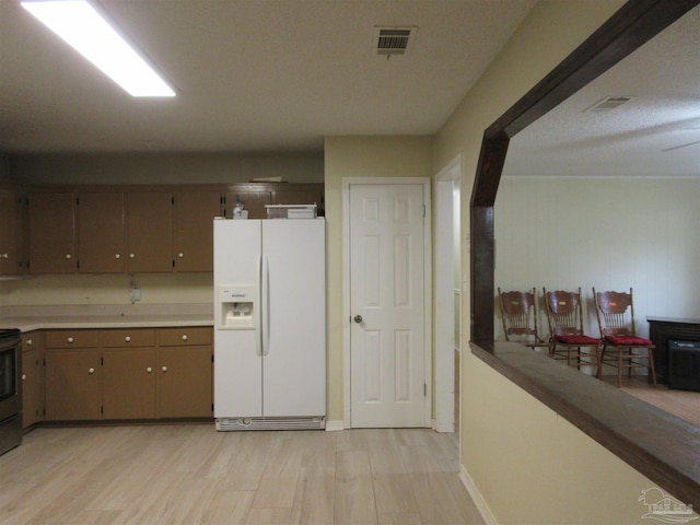 5078 Babb Ln, Pace, FL 32571 - kitchen featuring white fridge with ice dispenser, light wood finished floors, stainless steel range with electric stovetop, and light countertops