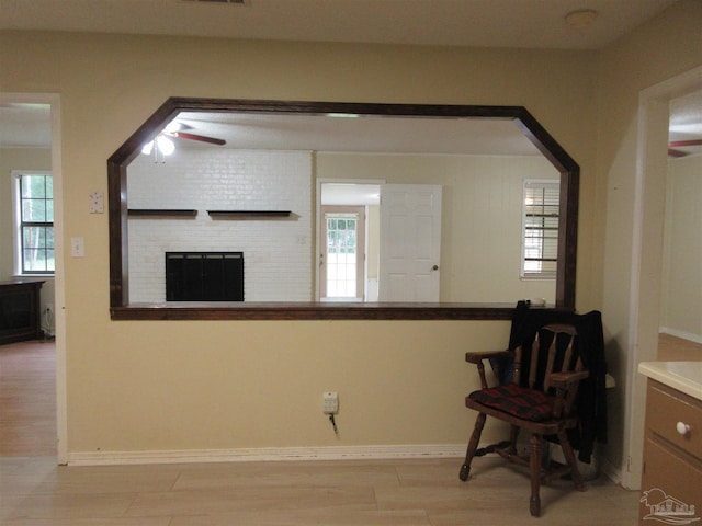 5078 Babb Ln, Pace, FL 32571 - sitting room featuring plenty of natural light, light wood finished floors, a ceiling fan, and a fireplace